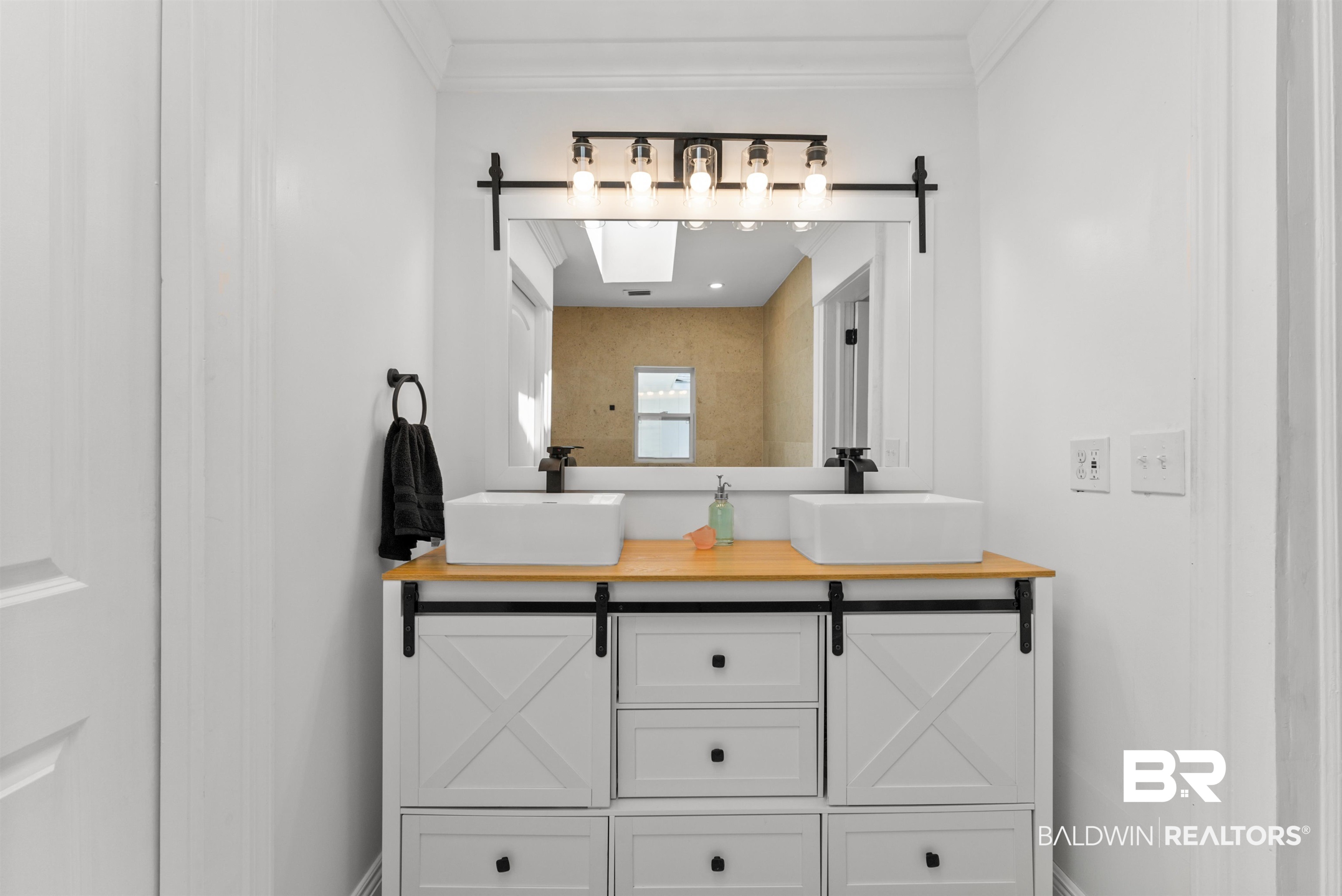 6447 Bemis Lane Bon Secour, AL 36511 - Photo 38 of 62 Dual vessel sinks with matte black fixtures set atop a wood-finish countertop