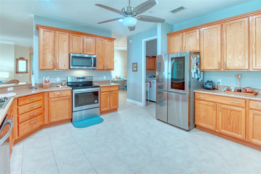 729 Glendora Road Kissimmee, FL 34759 - Photo 13 of 56 a kitchen with stainless steel appliances granite countertop a stove sink microwave and cabinets