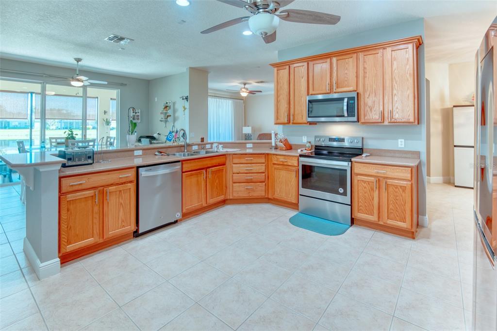729 Glendora Road Kissimmee, FL 34759 - Photo 14 of 56 a kitchen with stainless steel appliances granite countertop a stove sink and cabinets