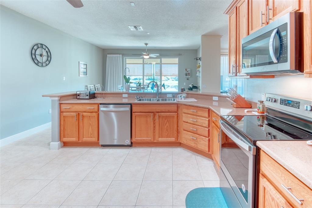 729 Glendora Road Kissimmee, FL 34759 - Photo 15 of 56 a kitchen with stainless steel appliances granite countertop a stove and a sink
