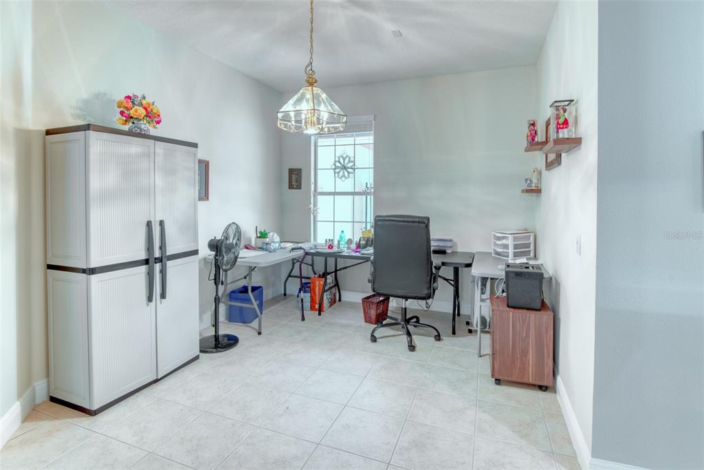 729 Glendora Road Kissimmee, FL 34759 - Photo 16 of 56 a view of a livingroom with workspace and a window