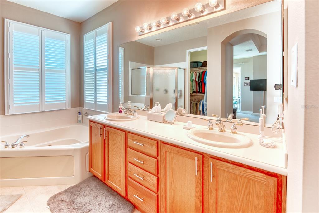 729 Glendora Road Kissimmee, FL 34759 - Photo 29 of 56 a bathroom with a granite countertop sink and a mirror
