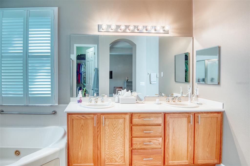 729 Glendora Road Kissimmee, FL 34759 - Photo 31 of 56 a bathroom with a double vanity sink mirror and bathtub