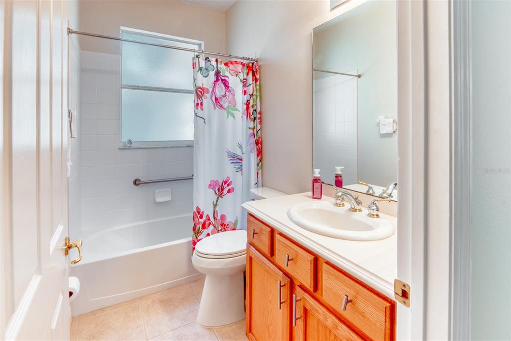 729 Glendora Road Kissimmee, FL 34759 - Photo 34 of 56 a bathroom with a sink vanity mirror and toilet