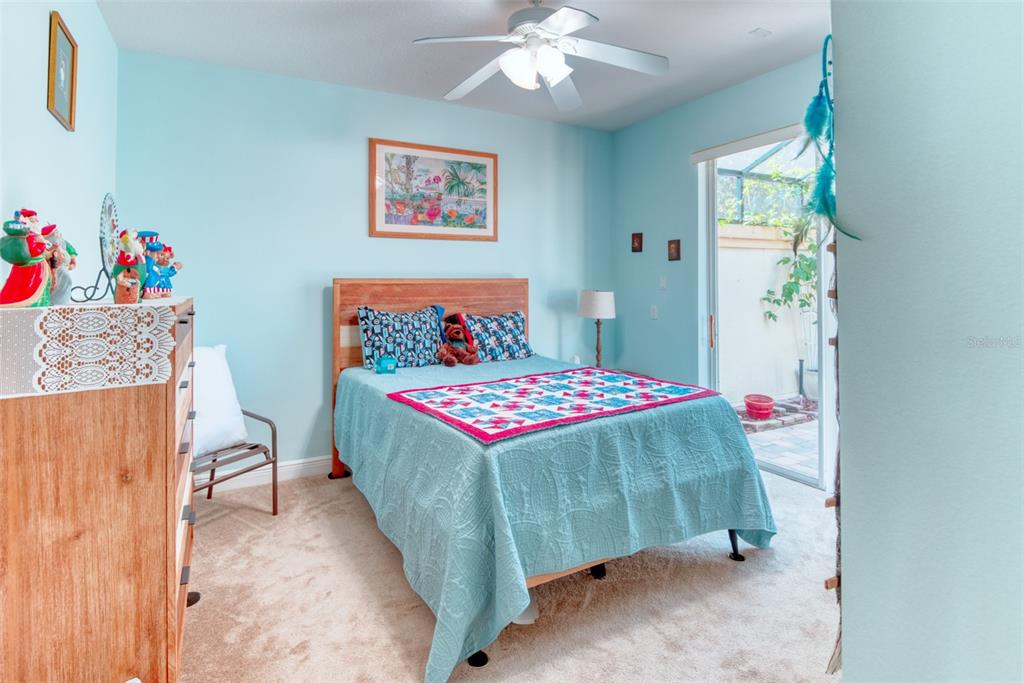 729 Glendora Road Kissimmee, FL 34759 - Photo 35 of 56 a bedroom with a bed and a chandelier