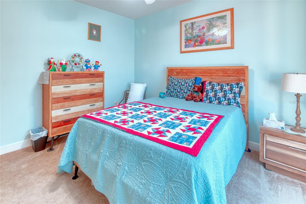 729 Glendora Road Kissimmee, FL 34759 - Photo 36 of 56 a bedroom with a bed and a dresser in it