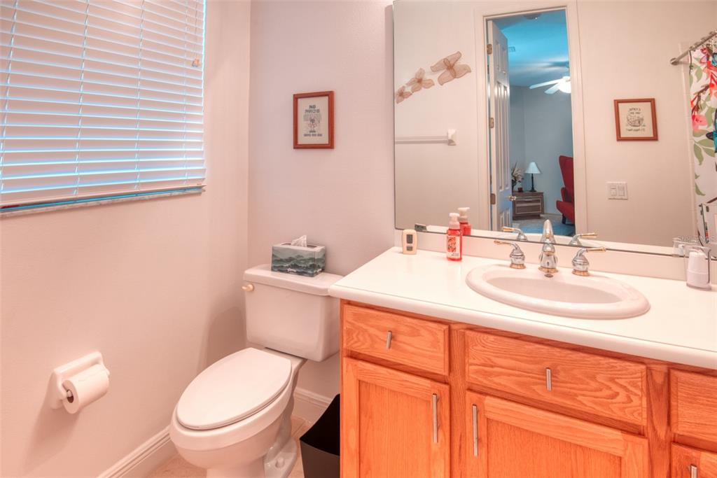 729 Glendora Road Kissimmee, FL 34759 - Photo 42 of 56 a bathroom with a toilet sink and mirror