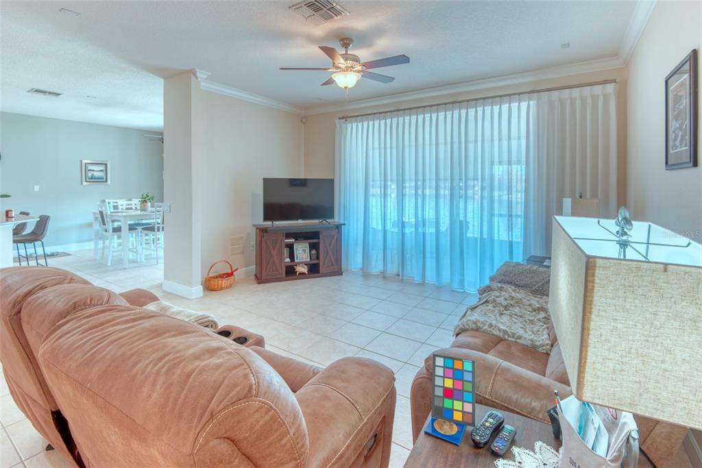 729 Glendora Road Kissimmee, FL 34759 - Photo 6 of 56 a bed room with a bed and a chandelier