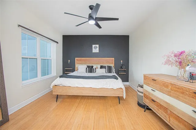 a bedroom with a bed and a potted plant