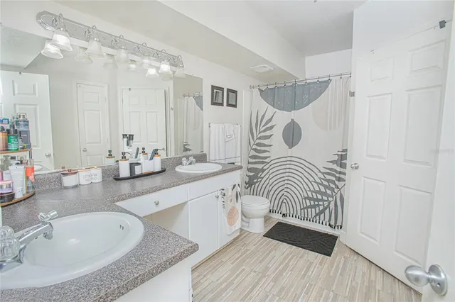 a bathroom with a sink a mirror and a shower