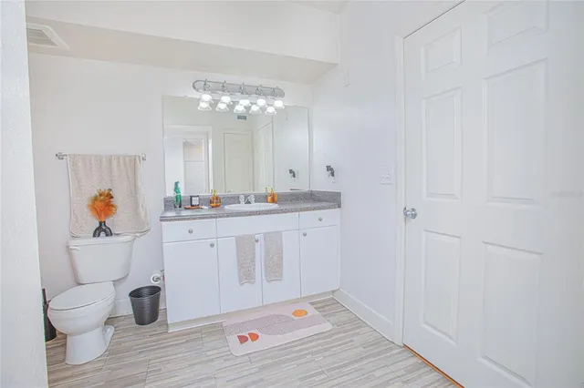 a kitchen with a sink and a toilet