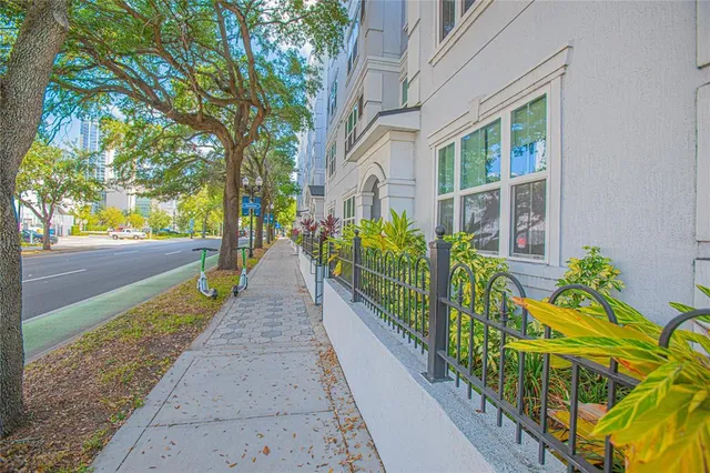 a view of a pathway that has a flower garden