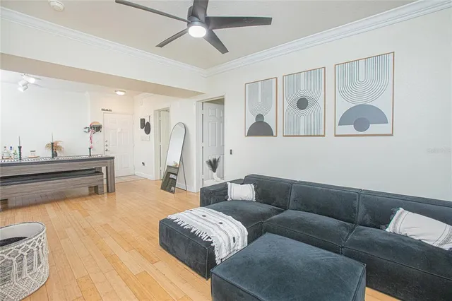 a living room with furniture and kitchen view