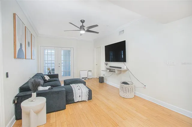 a living room with furniture a flat screen tv and a window