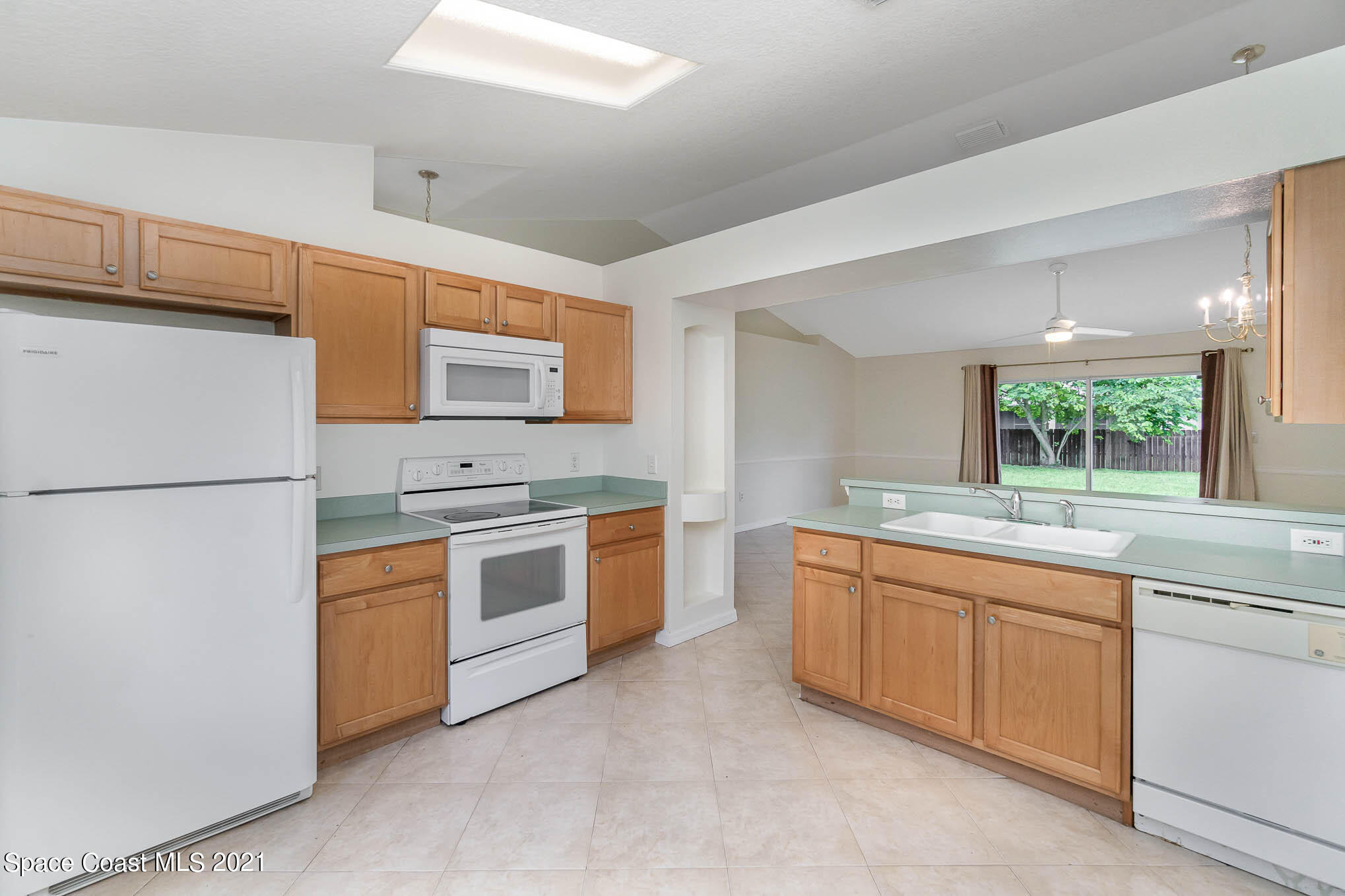 1380 Ran Road Southeast Palm Bay, FL 32909 - Photo 14 of 20 a kitchen with stainless steel appliances granite countertop a sink and a refrigerator