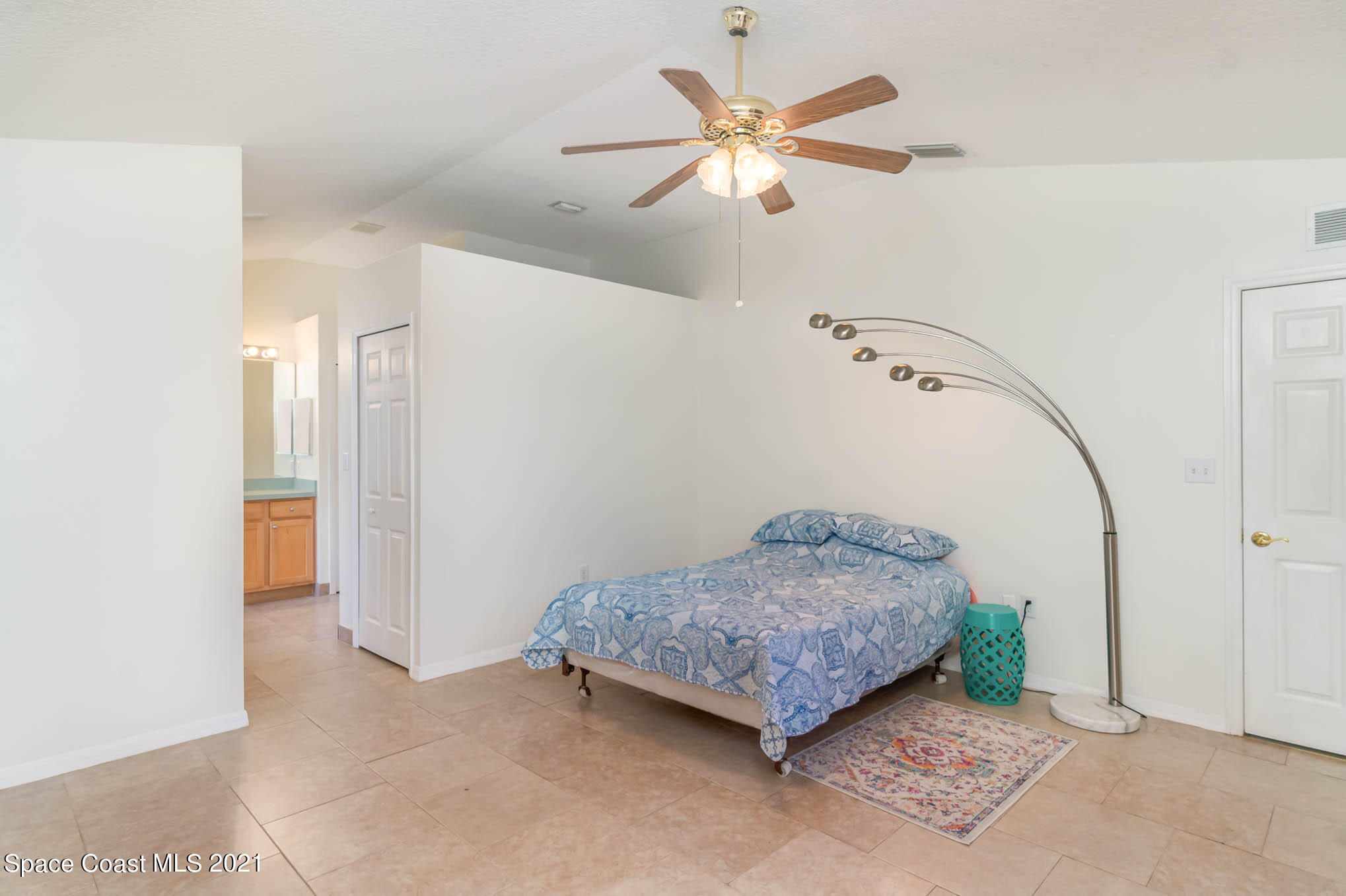 1380 Ran Road Southeast Palm Bay, FL 32909 - Photo 6 of 20 a bedroom with a bed and a chandelier