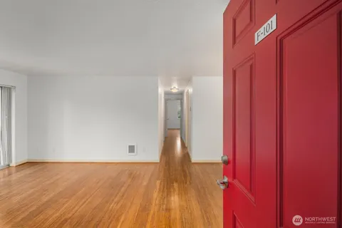 a view of a room with wooden floor and a window