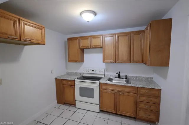 a view of an empty room with a fireplace and cabinet