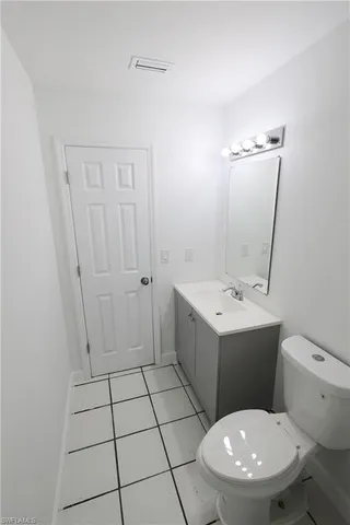 an empty room with chandelier fan