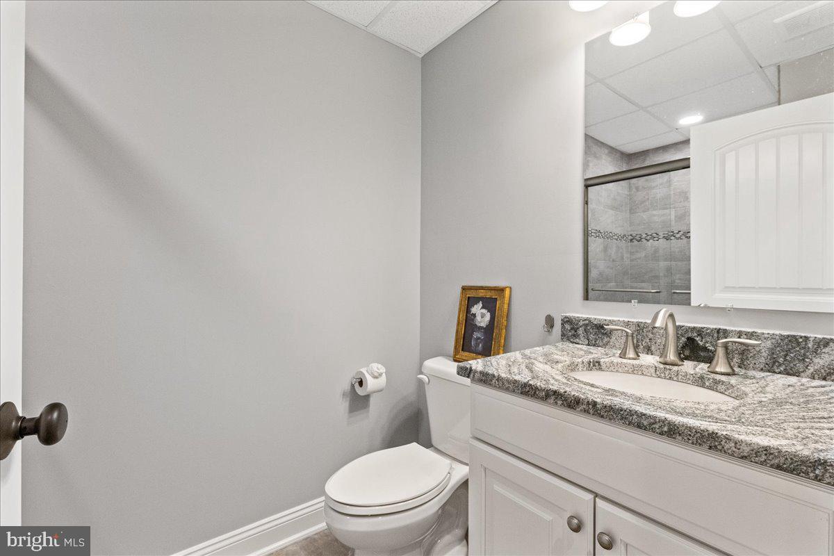 8 Harris Road Princeton, NJ 08540 - Photo 23 of 25 a bathroom with a granite countertop toilet sink mirror and vanity