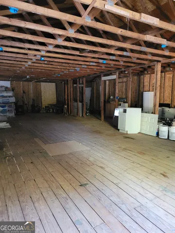 a view of a room with wooden floor