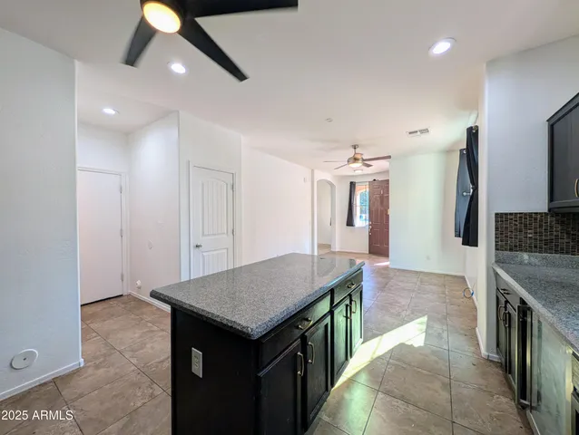 a view of an empty room with cabinet and a window