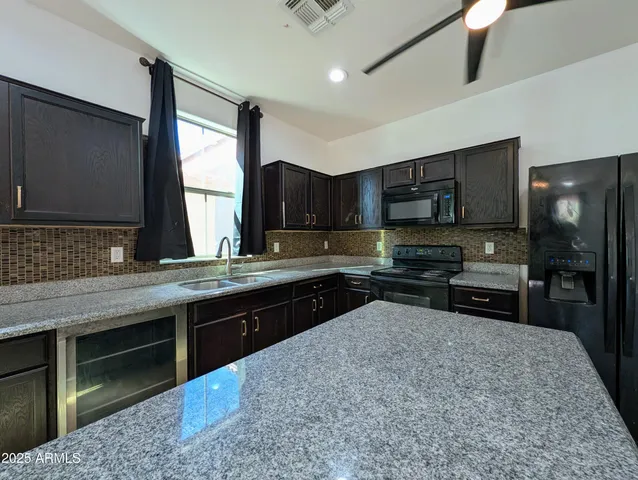 an empty room with closet and windows