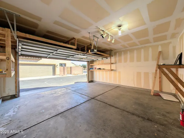 a en suite bathroom with a granite countertop sink and a mirror