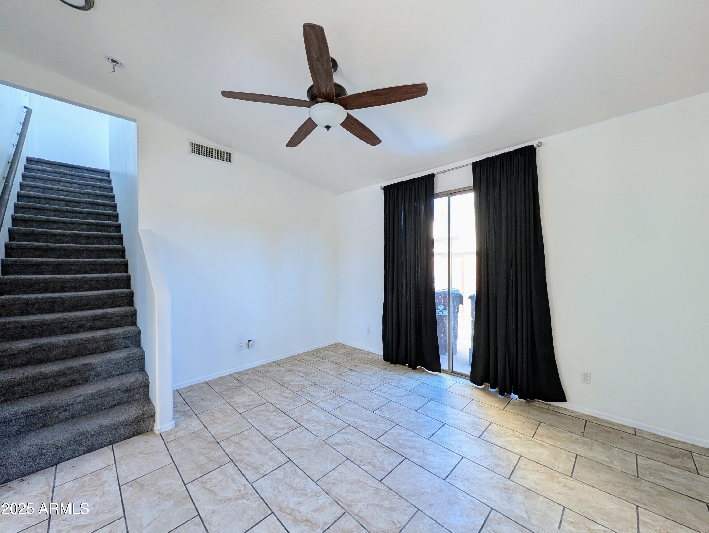 4726 West Fremont Rd. Laveen, AZ 85339 - Photo 20 of 50 a view of an empty room with wooden floor and windows