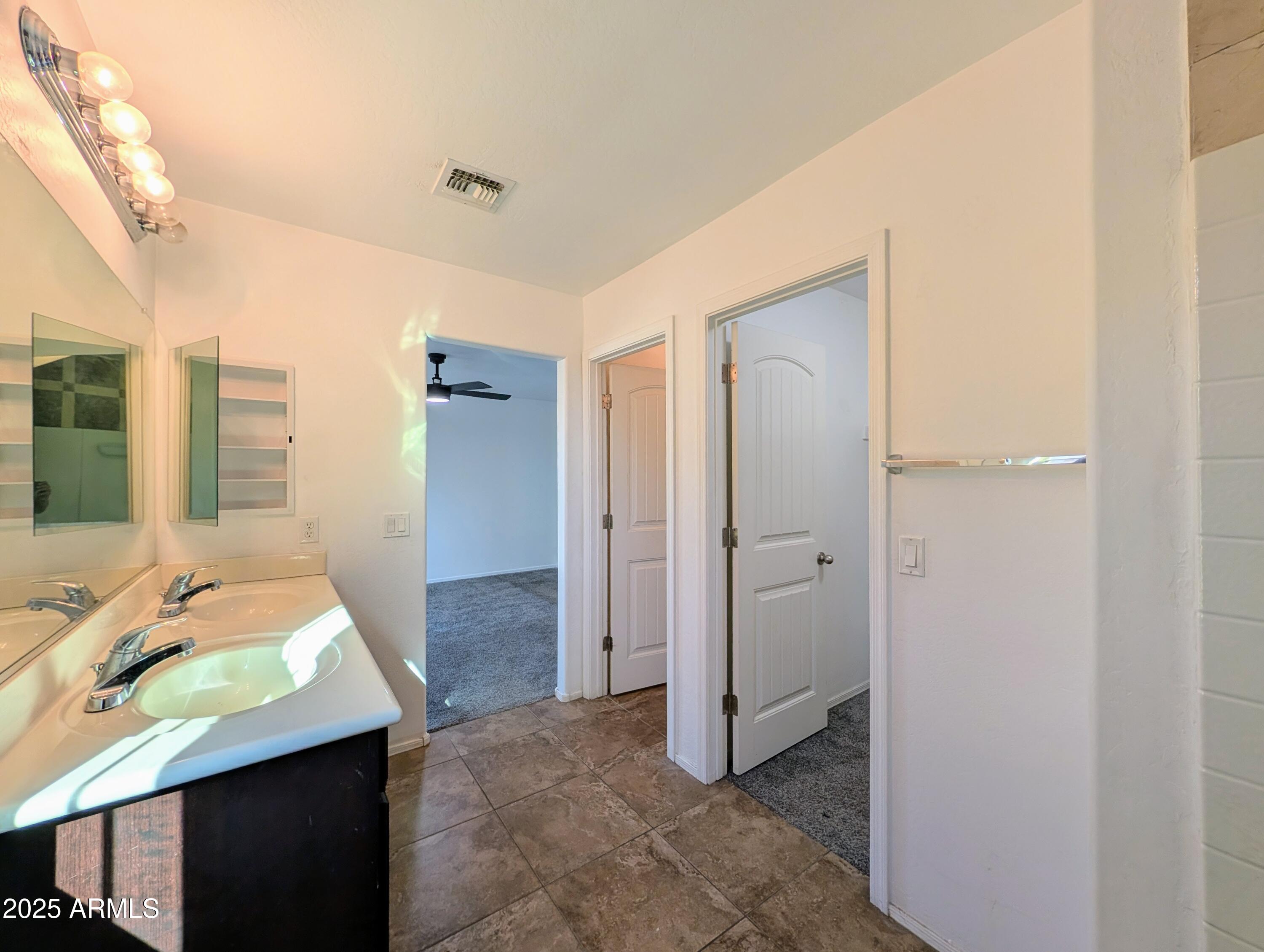 4726 West Fremont Rd. Laveen, AZ 85339 - Photo 34 of 50 a en suite bathroom with a granite countertop sink and a mirror