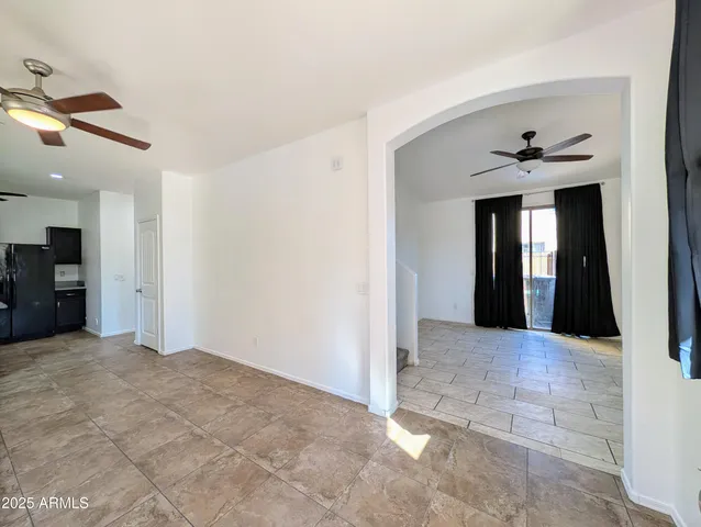 a view of an empty room with window and cabinet