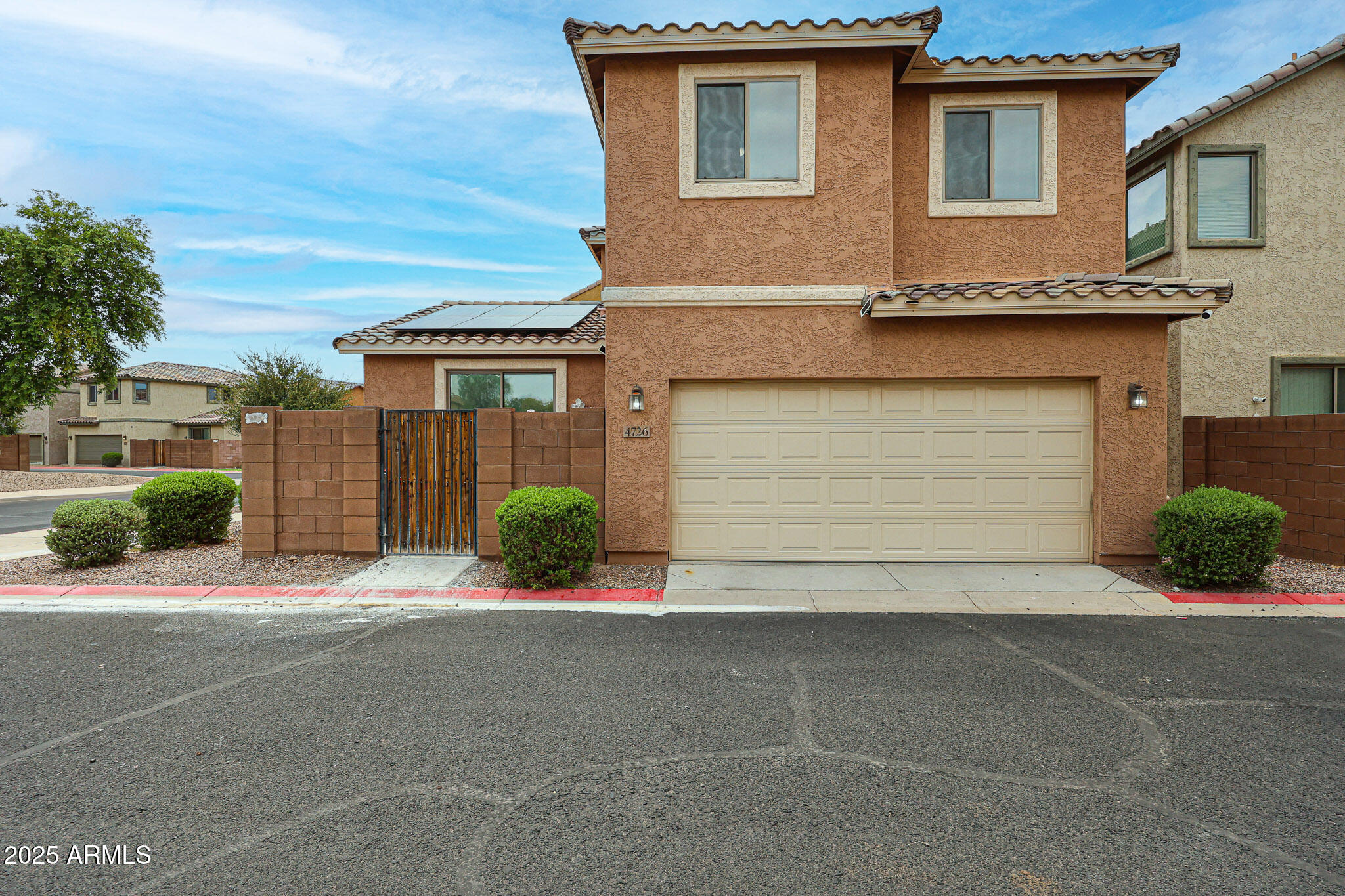 4726 West Fremont Rd. Laveen, AZ 85339 - Photo 47 of 50 a front view of a house with a yard and garage