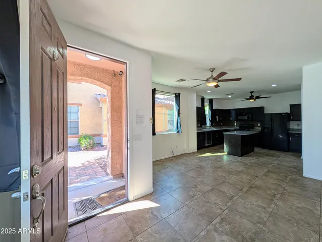 a kitchen with stainless steel appliances granite countertop a sink a stove and a refrigerator