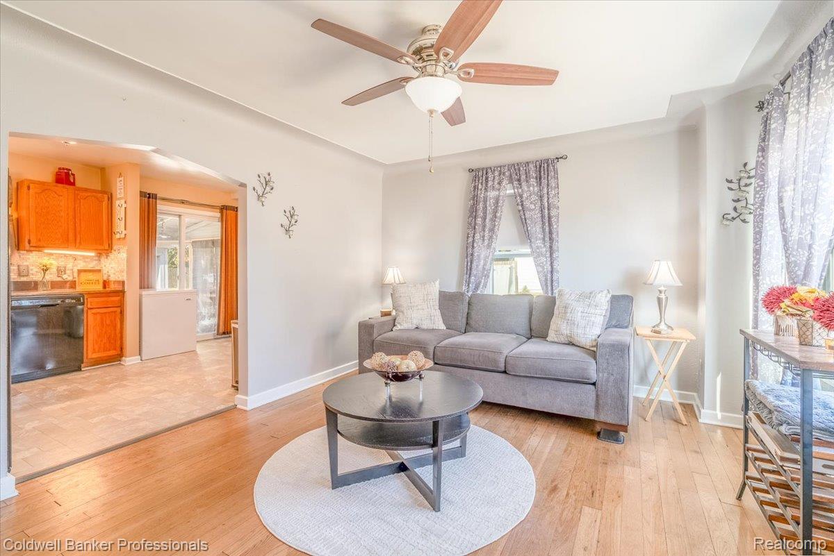 3582 Swanson Street Wayne, MI 48184 - Photo 7 of 30 Living room featuring light wood-style flooring, arched walkways, and ceiling fan