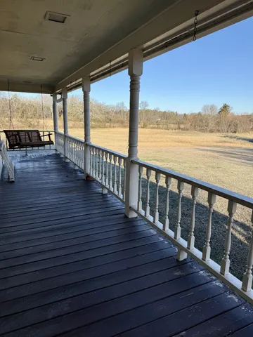 a view of a balcony with wooden floor