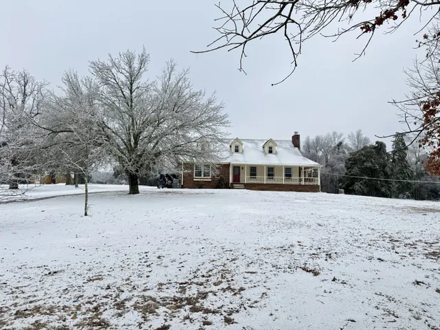 a white house with a snow in front of it