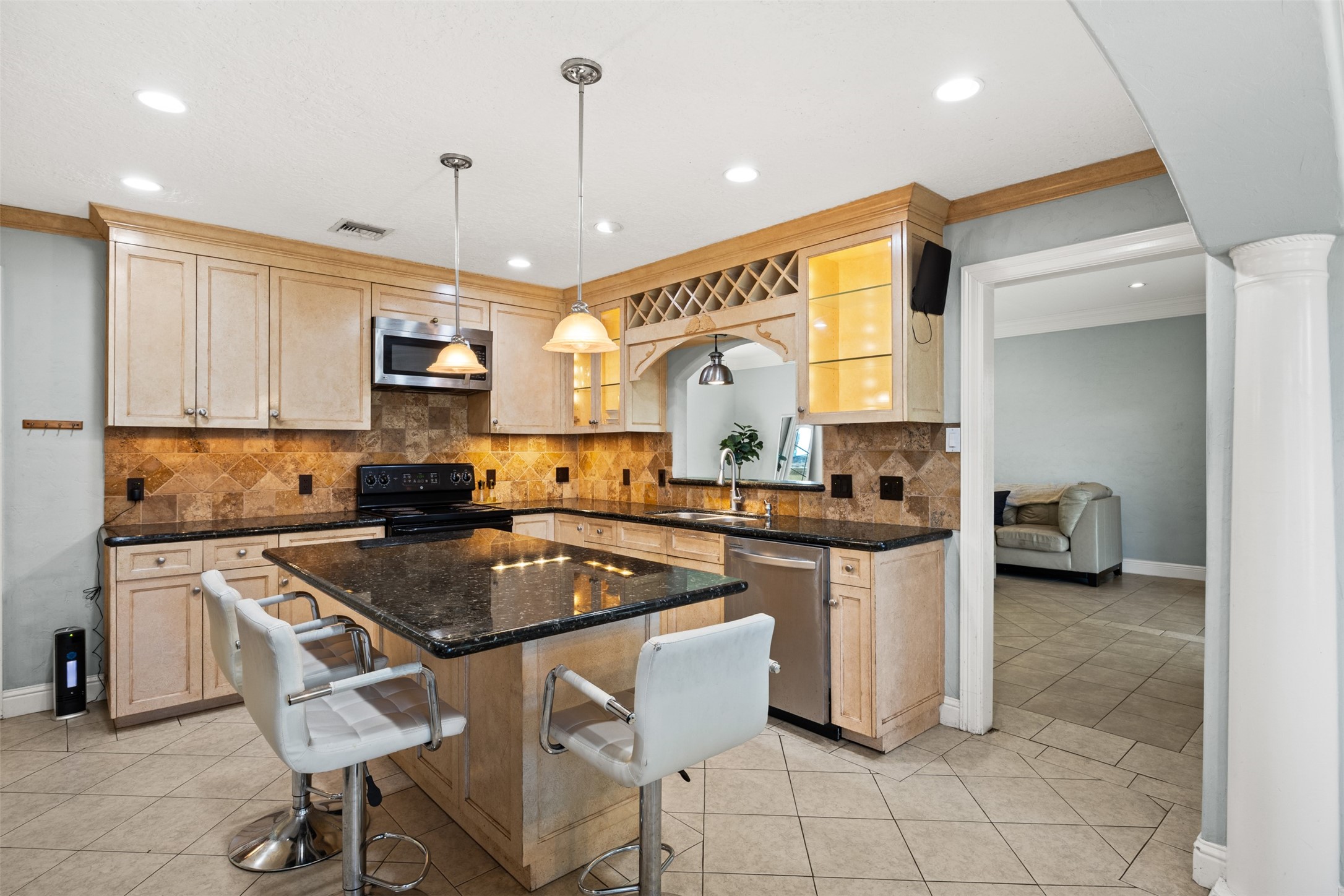 6830 Deer Ridge Lane Houston, TX 77086 - Photo 13 of 24 a kitchen with kitchen island granite countertop a sink counter top space appliances and cabinets