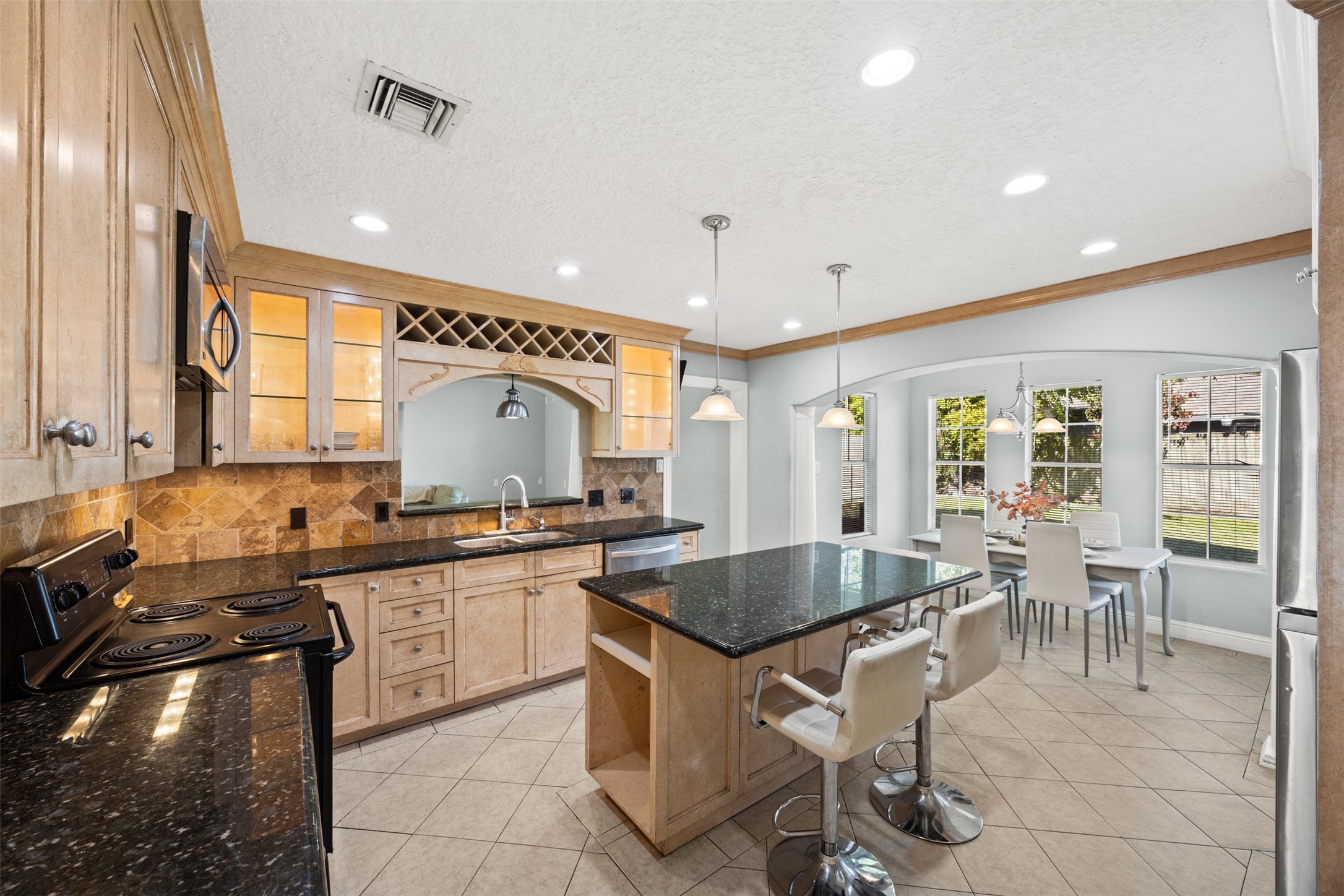 6830 Deer Ridge Lane Houston, TX 77086 - Photo 14 of 24 a kitchen with a stove a sink and a refrigerator