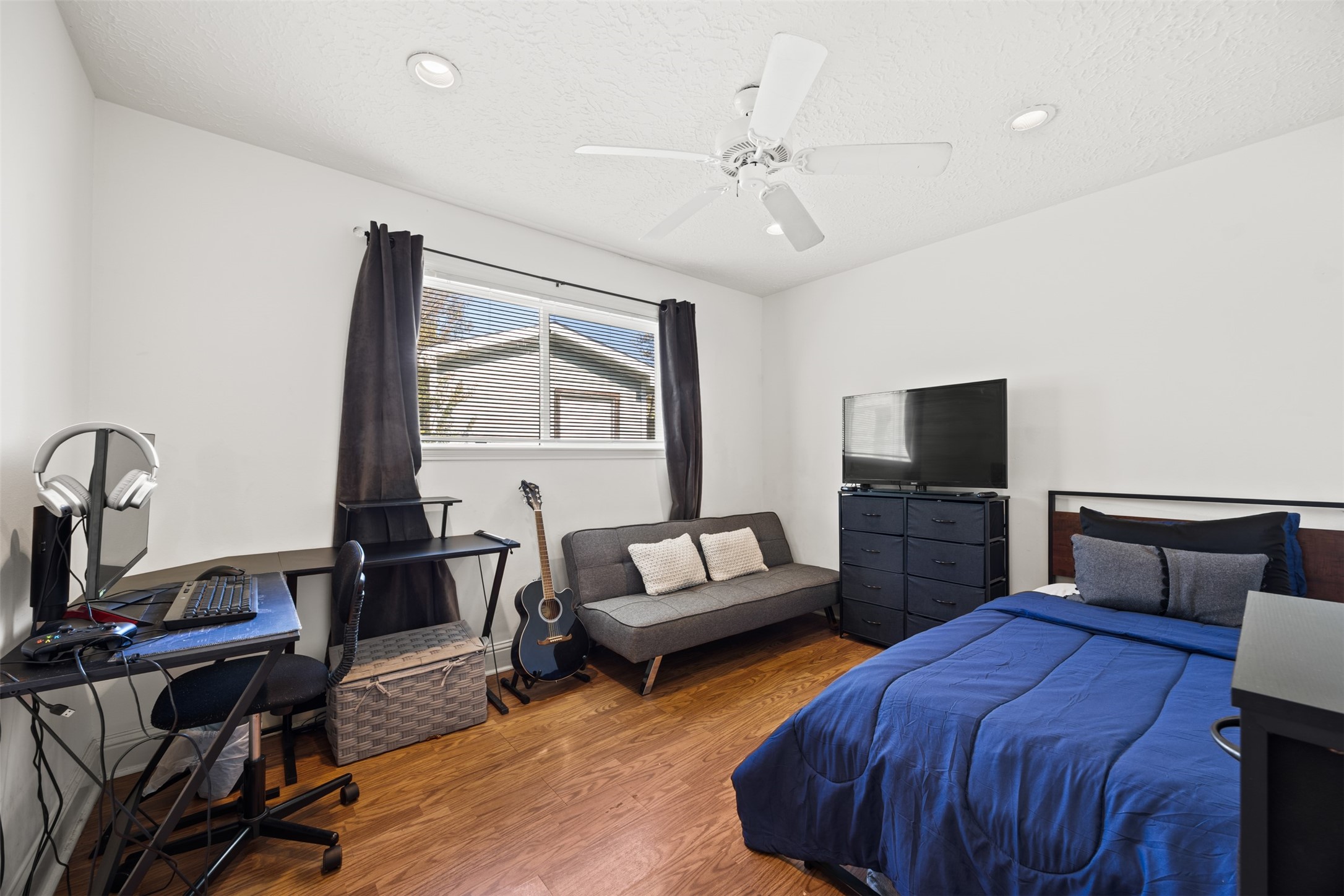 6830 Deer Ridge Lane Houston, TX 77086 - Photo 18 of 24 a bedroom with furniture and a flat screen tv