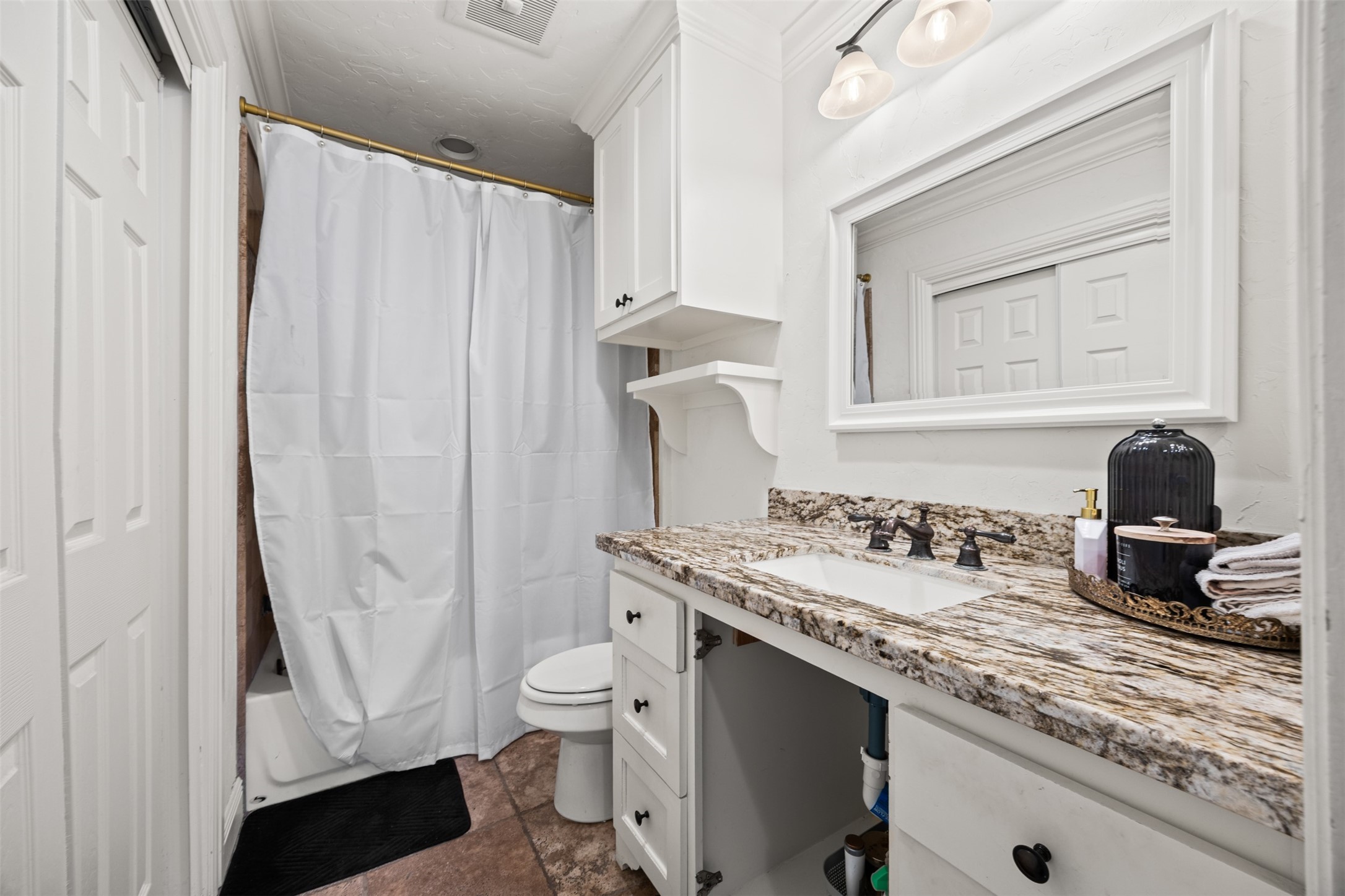 6830 Deer Ridge Lane Houston, TX 77086 - Photo 21 of 24 a bathroom with a granite countertop sink toilet and shower