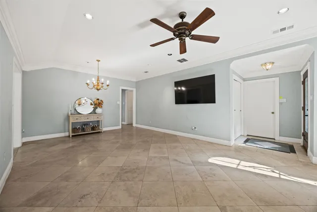 a living room with a flat screen tv and white walls