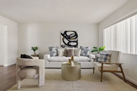 a living room with furniture and wooden floor