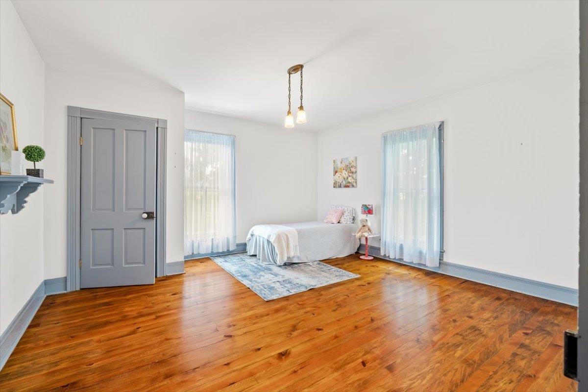 1188 Patterson Mill Road Grottoes, VA 24441 - Photo 30 of 58 a bedroom with a bed and wooden floor