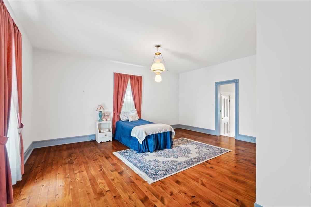1188 Patterson Mill Road Grottoes, VA 24441 - Photo 33 of 58 a bedroom with a bed and wooden floor