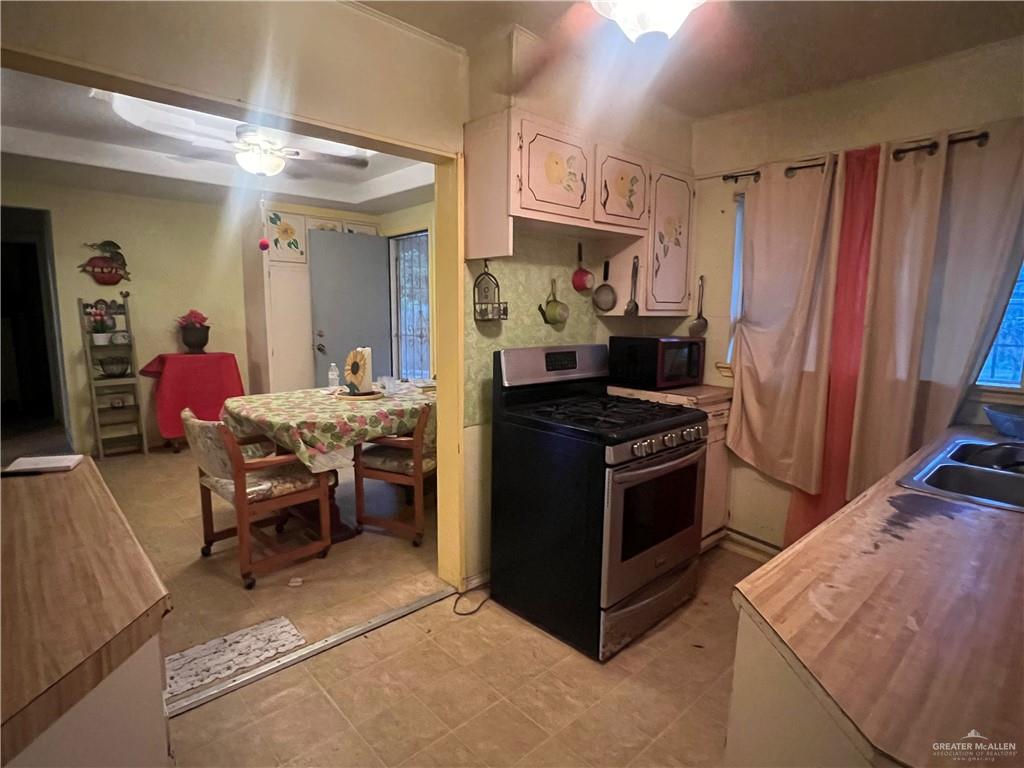 409 South 24th Street Donna, TX 78537 - Photo 4 of 11 a kitchen with a sink appliances and cabinets