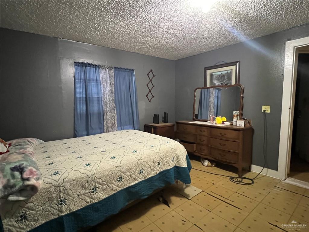 409 South 24th Street Donna, TX 78537 - Photo 6 of 11 a bedroom with a bed and a dresser in it