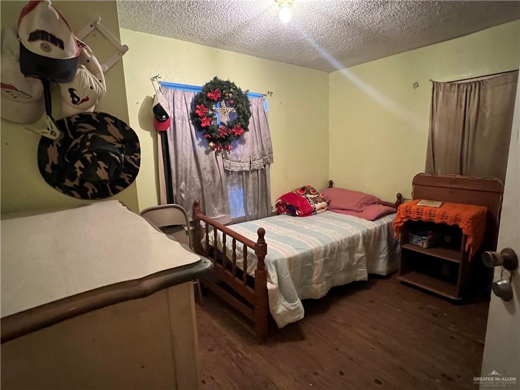 409 South 24th Street Donna, TX 78537 - Photo 7 of 11 a bedroom with a bed and a dresser