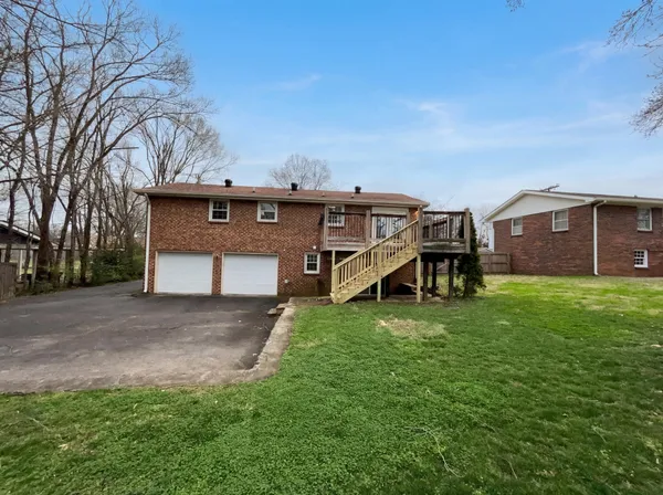a view of a house with a backyard and a patio