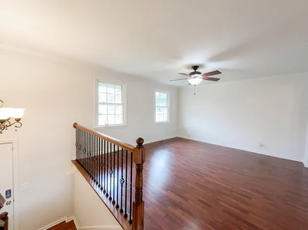 a view of a livingroom with wooden floor and a window
