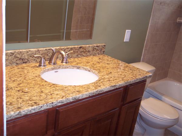 25 Lindsay Road Springfield, MA 01128 - Photo 8 of 30 a bathroom with a granite countertop sink and a toilet